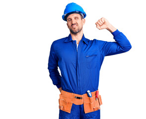 Young handsome man wearing worker uniform and hardhat stretching back, tired and relaxed, sleepy and yawning for early morning