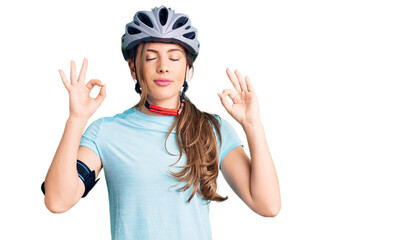 Beautiful caucasian young woman wearing bike helmet relax and smiling with eyes closed doing meditation gesture with fingers. yoga concept.