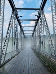 misty bridge over river