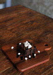 Homemade Chocolate brownie topping with marshmallow on wooden background