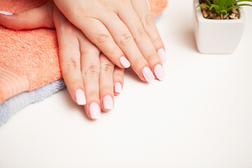 Woman close up demonstrates a fresh manicure
