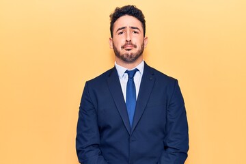 Young hispanic man wearing suit depressed and worry for distress, crying angry and afraid. sad expression.