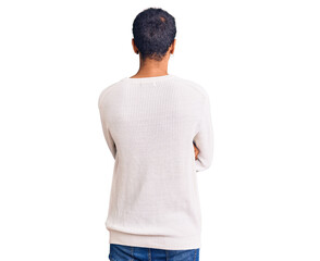 Young african amercian man wearing casual clothes standing backwards looking away with crossed arms