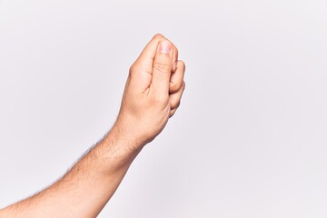 Close up of hand of young caucasian man over isolated background holding blank space with thumb finger, business and advertising