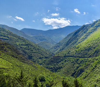 panoramic landscape of blue sky over the green hills and mountains