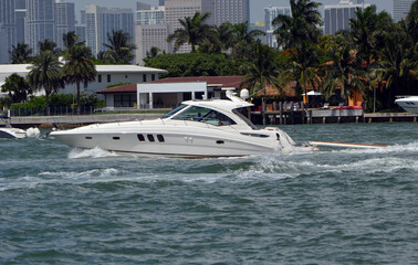Obraz premium Well appointed cabin cruiser on the Florida Intra-Coastal Waterway off of Miami Beach.