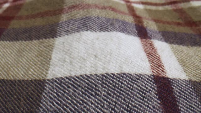 Close up slide over a plaid shirt.