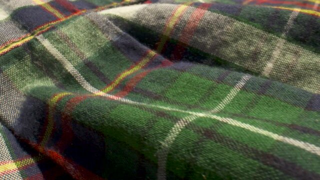 Close up over the fabric of a plaid flannel shirt.