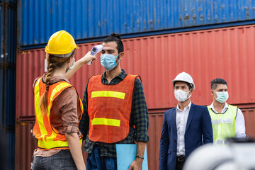 Engineer worker wearing surgical mask checking body temperature using infrared digital thermometer check temperature before into workplace, workers with protective mask