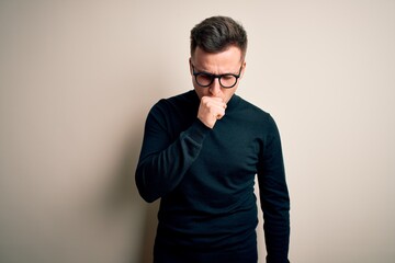 Young handsome caucasian man wearing glasses and casual sweater over isolated background feeling unwell and coughing as symptom for cold or bronchitis. Health care concept.
