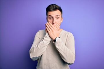 Fototapeta premium Young handsome caucasian man wearing casual sweater over purple isolated background shocked covering mouth with hands for mistake. Secret concept.