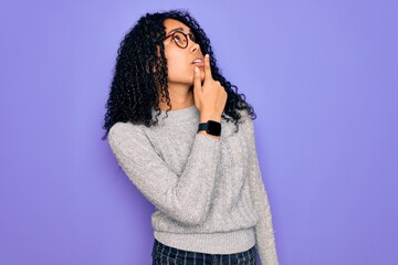 Young african american woman wearing casual sweater and glasses over purple background Thinking worried about a question, concerned and nervous with hand on chin