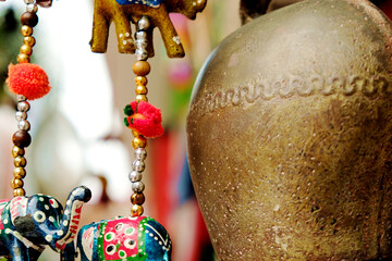 Decorative tin yak bell, beads and paper animal figures - symbols and signs of indian (hindu) and buddhist religions and tradition. - obrazy, fototapety, plakaty