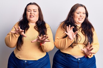 Young plus size twins wearing casual clothes disgusted expression, displeased and fearful doing disgust face because aversion reaction.