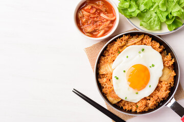 Kimchi fried rice with fried egg on top in small cooking pan, Korean food