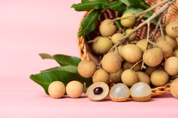 Longan fruit in a basket on pink background, Tropical fruit
