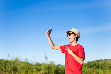 Digital Influencer. Happy young man taking selfie with his smartphone.