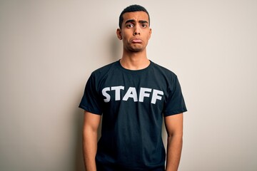 Young handsome african american worker man wearing staff uniform over white background depressed and worry for distress, crying angry and afraid. Sad expression.
