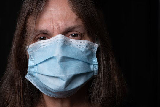 Close Up Of A Woman Wearing A Disposable Face Mask For Covid 19 Protection