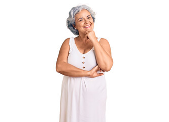 Senior woman with gray hair wearing casual clothes looking confident at the camera with smile with crossed arms and hand raised on chin. thinking positive.