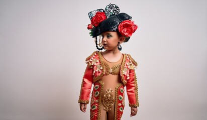 Young little caucasian kid girl wearing  bullfighter traditional folkore spanish suit as carnival...