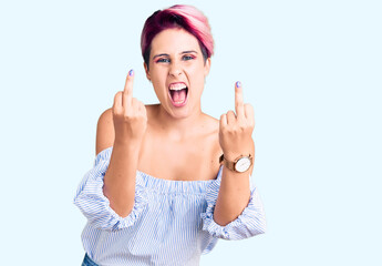 Young beautiful woman with pink hair wearing casual clothes showing middle finger doing fuck you...