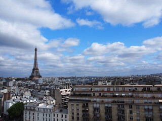 Paris skyline with an impressive Eiffel Tower in the pleasant blue sky.