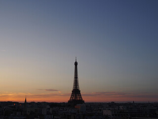 Fototapeta na wymiar Paris skyline with an impressive Eiffel Tower in the pleasant sunset sky.