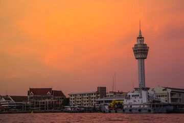 Fototapeta na wymiar Riverfront view of Samut Prakan city hall with new observation tower and boat pier. Samut Prakan is at the mouth of the Chao Phraya River on Gulf of Thailand.