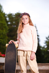 Teenager Lifestyle. Natural portrait of  Happy Caucasian Teenager Girl Posing With Longboard Outdoors On Stairs.