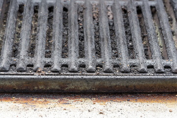 Dirty barbecue grill close up with charred grates