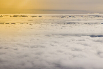 Beautiful cloudscape and blue sky from aerial view, nature view from above the sky and clouds. White clouds and blue sky view like the heaven from airplane window. Sunlight in the sky shines on clouds