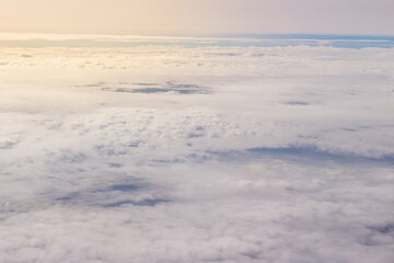 Fototapeta na wymiar Beautiful cloudscape and blue sky from aerial view, nature view from above the sky and clouds. White clouds and blue sky view like the heaven from airplane window. Sunlight in the sky shines on clouds
