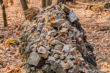 Large granite boulder next to hiking trail.