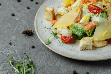 Caesar salad with salmon and fresh vegetables. Top view. Free space for your text