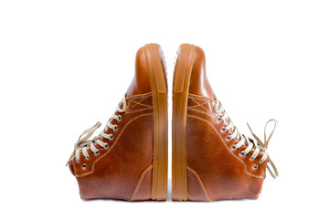 Motorcyclist Footwear Concepts. Pair of Motorcycling Tanned Leather Protective Sneakers Placed Over White Background.