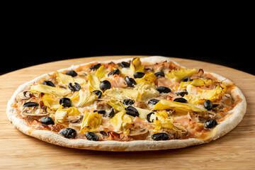Homemade traditional capricciosa pizza close up
