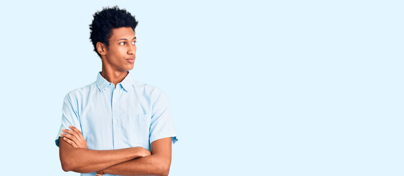 Young african american man wearing casual clothes looking to the side with arms crossed convinced and confident