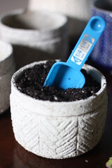Potting Soil in Garden Pot with Blue Scoop