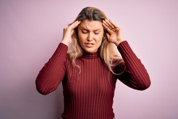 Young beautiful blonde woman wearing casual sweater over isolated pink background with hand on head for pain in head because stress. Suffering migraine.