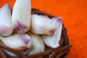 Cloves of raw Garlic in wooden small vintage nest as bowl. Spices for cooking