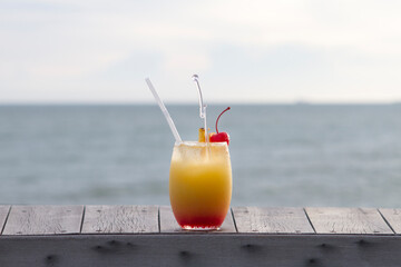 Glass of fruit punch with ocean view