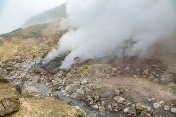 Picturesque view of volcanic landscape, aggressive hot spring, erupting fumarole, gas-steam activity in crater active volcano. Scenery mount landscape, travel destinations for hike, active vacation.