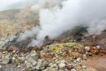 Breathtaking view of volcanic landscape, aggressive hot spring, eruption fumarole, gas-steam...