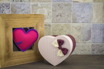 Heart in a wooden frame with a gift box