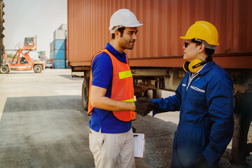 Shaking hands teamwork of industrial technicians working in the establishment, container, friendship between a variety of races, among which effective collaboration.
