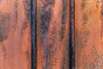 Texture of fluted rusty metal plate. Corrugated