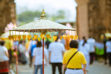 Umbrellas decorated with leaves in Kathin ceremony.