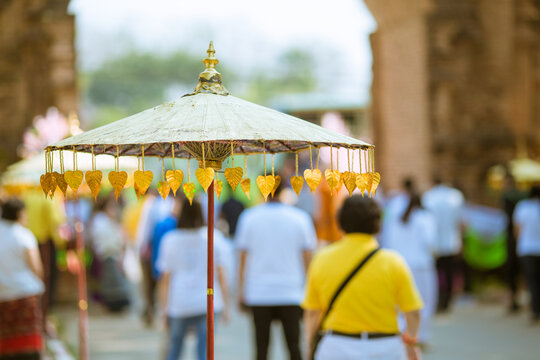 Umbrellas decorated with leaves in Kathin ceremony.