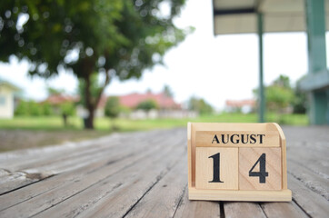 August 14, Number cube with a natural background.